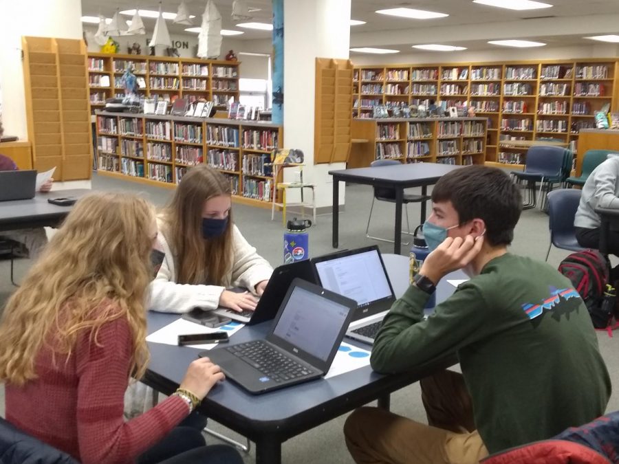 Seniors (clockwise from left) Aria Garceau (21), Emma Bapp (21) and Will Dumont (21) work on completing their college applications.  Photo credit:  Alisa Aylward 