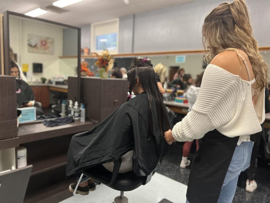 An NCTC cosmetology student does another students hair. Photo credit: Ivy Hoang