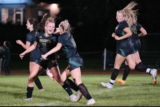 BFA’s Tessa Sweeney ('24) #11 and Alayna Carpenter ('23) #6 come together to celebrate Sweeney’s free-kick goal with Mckenna Hughes ('23) giving a huge smile behind them. Photo Credit: Messenger photographer Ari Beauregard