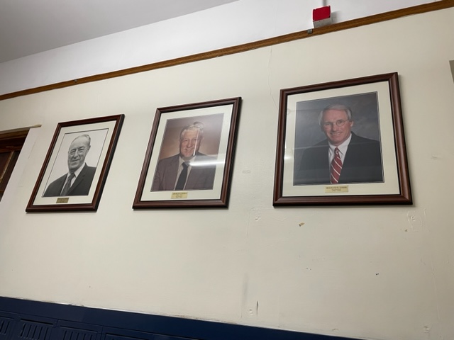 Photos of former principals hang in the hallway of BFA. Photo credit:  Larissa Hebert