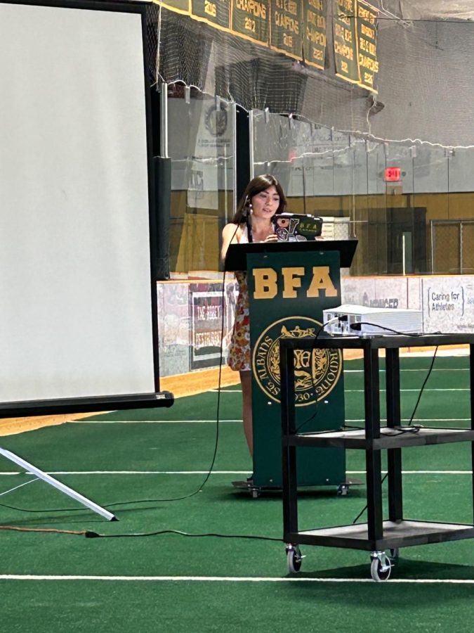 Leah Fitzgerald gives Brett Blanchards retirement farewell speech at the BFA end-of-year faculty luncheon.  Photo credit:  Theresa Callan
